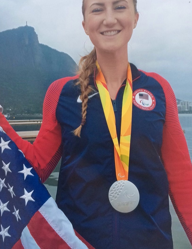 Dani Hansen smiling proudly wearing her silver medal at the Rio Paralympic Games.