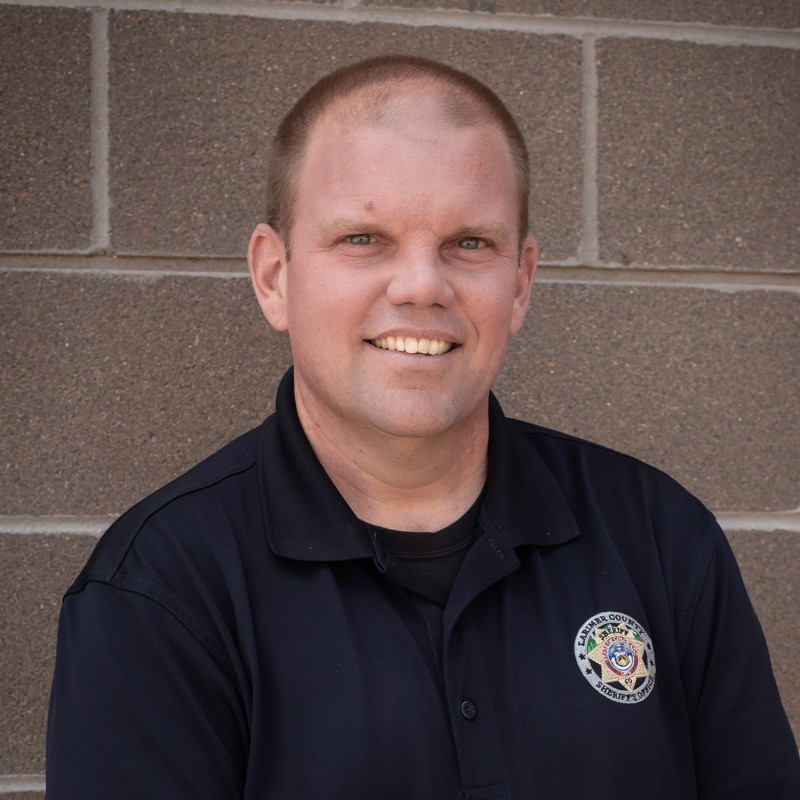 Deputy Chris Smith in his uniform smiling at the camera. 