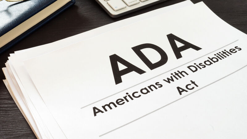 Paper on desk that says ADA Americans with Disabilities Act