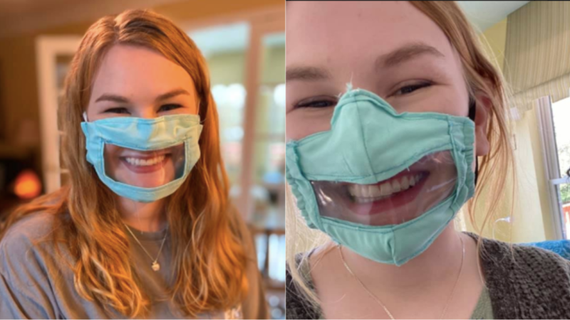 Woman wearing a surgical mask with a see-through window showing her mouth.