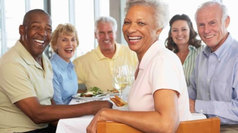 A group of elderly people smiling.
