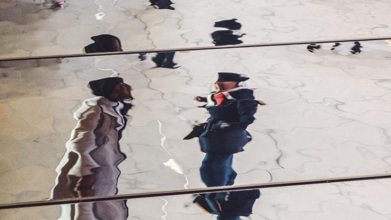 two people in a watery reflection