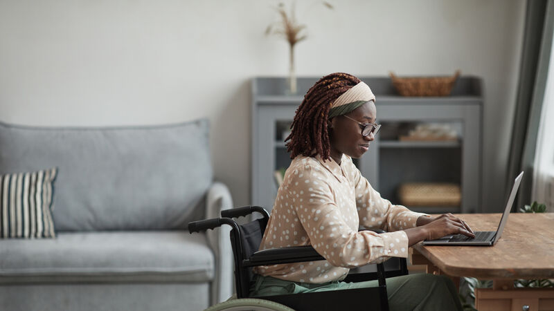 Black woman in a wheelchair working from home