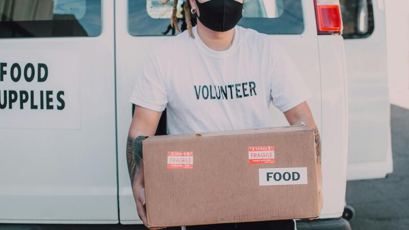 Volunteer unloading food from a van