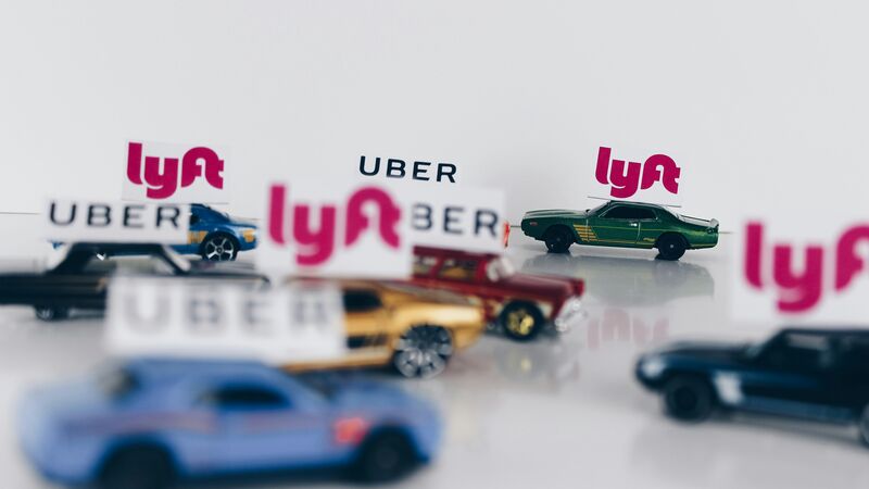 Toy cars with Uber and Lyft signs