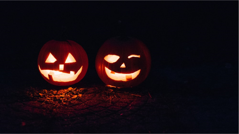 Two lighted jack-o-lanterns during night time.