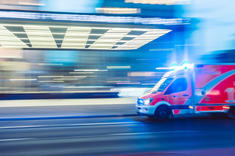 An ambulance rushes through a city