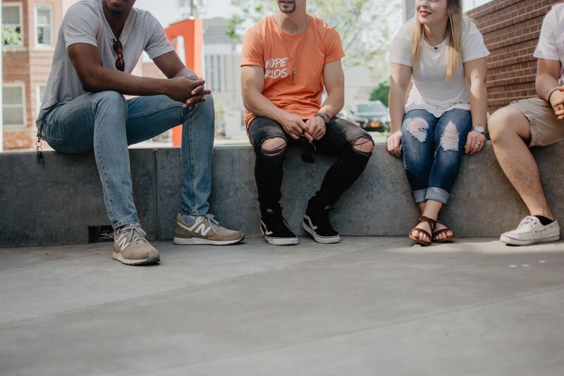 People sitting in a semi-circle having a conversation.