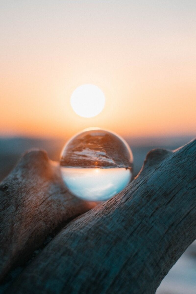 Sun rising behind a glass crystal ball.