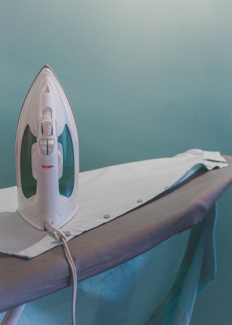 Electric iron on an ironing board