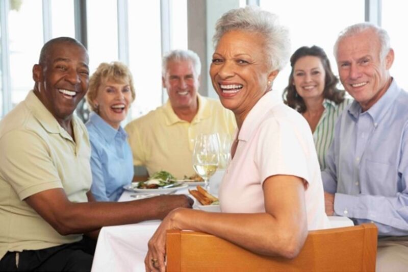 A group of elderly people smiling.