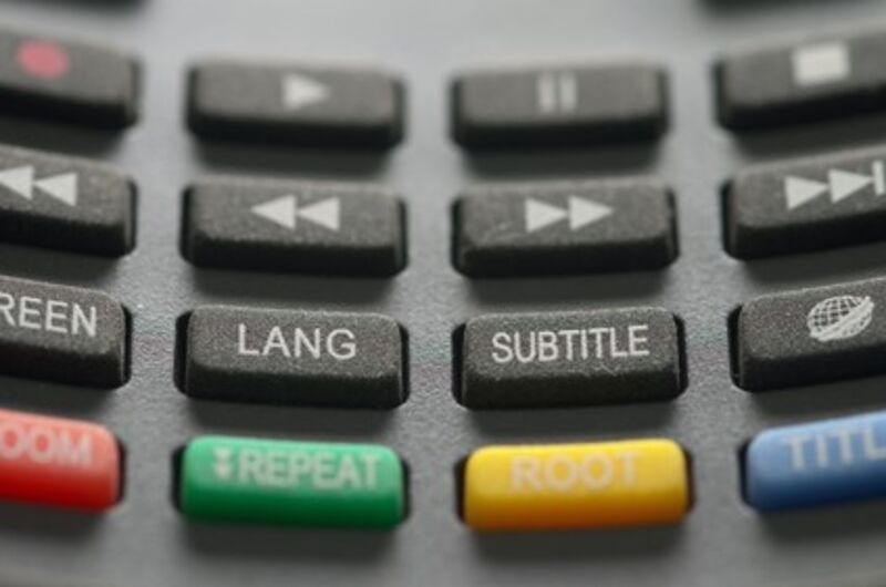 Close-up shot of a remote control and its different buttons.