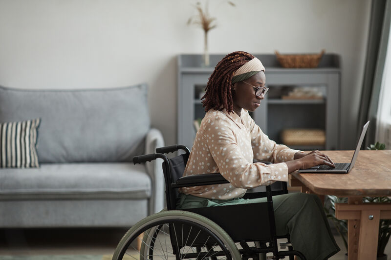 Black woman in a wheelchair working from home