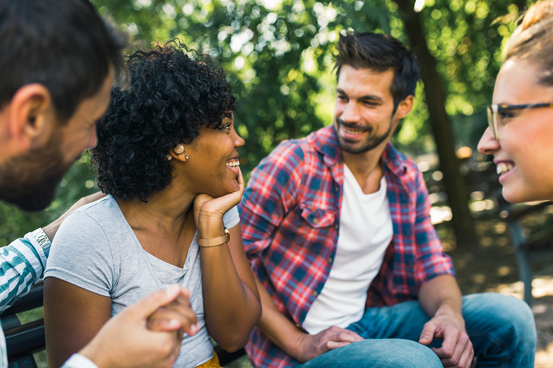 woman with hearing aid having fun with her friends at the park