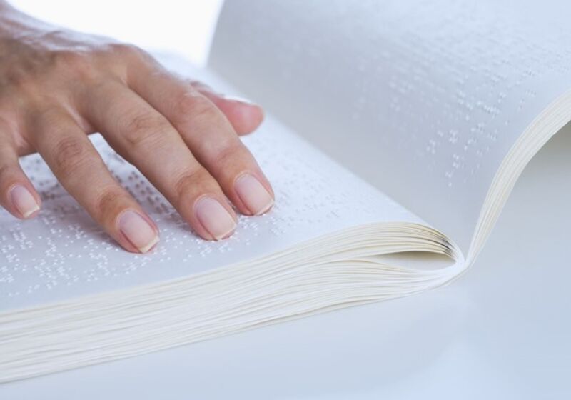 Hand upon braille book