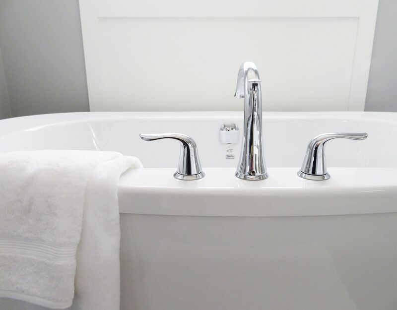 white bathtub with a white towel on it