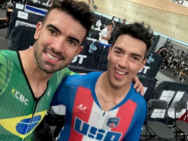 A selfie with Chris Murphy and Brazilian Paracyclist Lauro Chaman after racing, each wearing their national team speedsuits.