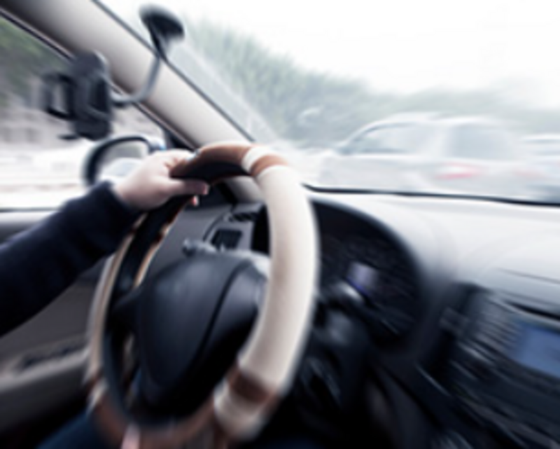 a blurred picture of a person driving a car