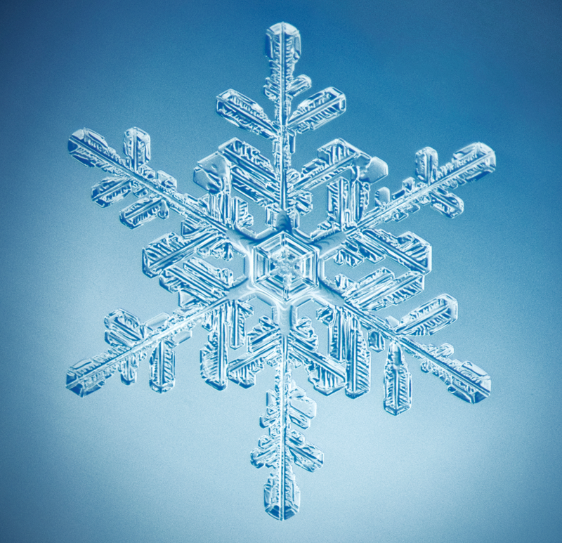 a close up of a snowflake on a blue background