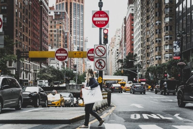 Woman crossing a busy street