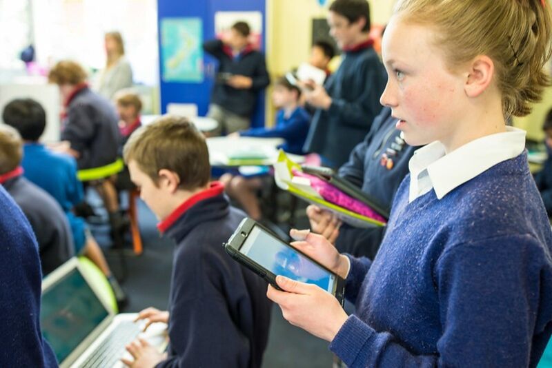 students in the classroom using a variety of technology