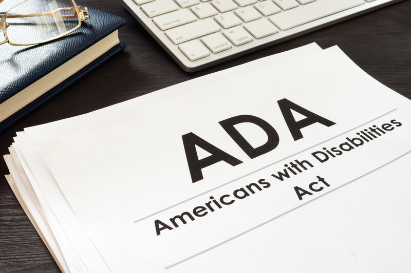 Paper on desk that says ADA Americans with Disabilities Act