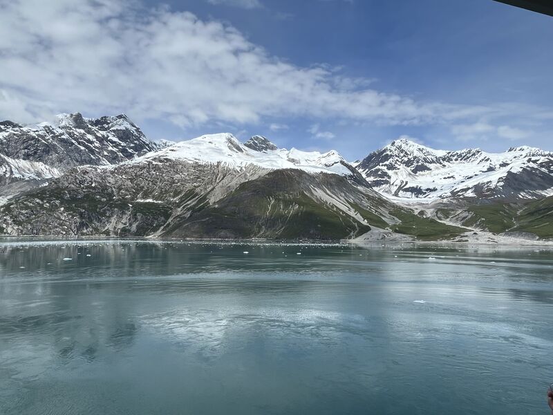 a pano of snowcapped mountains and a lake