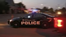Oklahoma police car driving on a street.