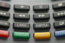 Close-up shot of a remote control and its different buttons. 