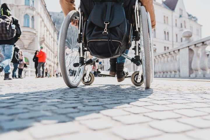 person in wheelchair on bridge