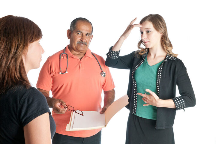 a doctor asking a patient if they are sick, the patient is looking at an ASL interpreter signing "sick"