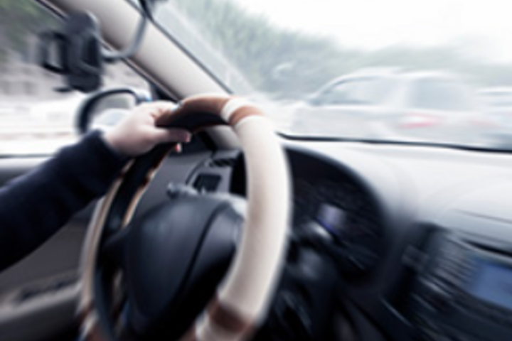 a blurred picture of a person driving a car