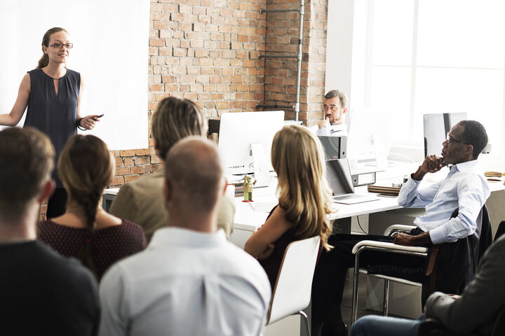 a woman presenting to a group of people