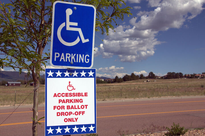 an accessible parking sign and a ballot box drop-off sign with the words Accessible Parking for Ballot Drop-Off Only