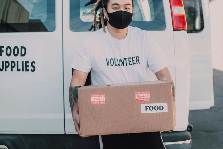 Volunteer unloading food from a van