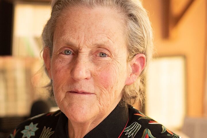 Temple Grandin wears a colorful floral embroidered top and monogrammed tie.