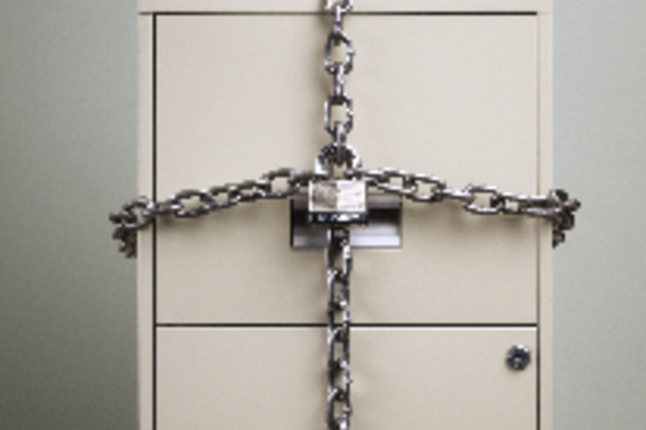 filing cabinet with drawers locked with chains