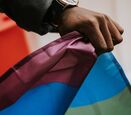 Close up of hand holding pride flag