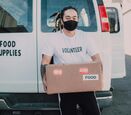 Volunteer unloading food from a van