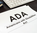 Paper on desk that says ADA Americans with Disabilities Act