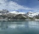 a pano of snowcapped mountains and a lake