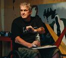 Murray Siple in his wheelchair uses spray paint to create art.
